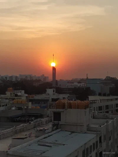 The sun setting over rooftops