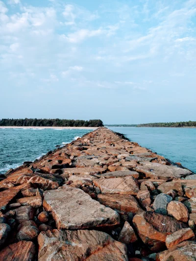A rocky breakwater stretching into the sea